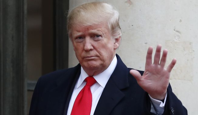 U.S President Donald Trump waves as he arrives for a lunch the Elysee Palace after ceremonies Sunday, Nov. 11, 2018 in Paris. International leaders attended a ceremony in Paris on Sunday at mark the 100th anniversary of the end of World War I. (AP Photo/Thibault Camus)