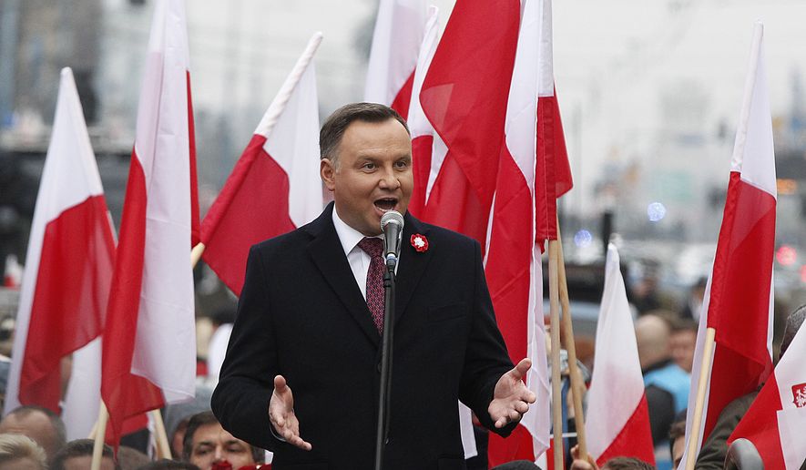 Poland's President Andrzej Duda speaks at the start of a massive march marking 100 years since Poland regained independence in Warsaw, Poland, Sunday, Nov. 11, 2018. Poland's president, prime minister and other top leaders led an Independence Day march Sunday that included members of nationalist organizations, the first time Polish state officials have marched with the far-right groups. (AP Photo/Czarek Sokolowski)