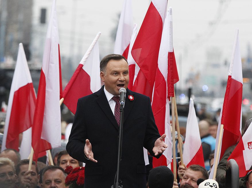 Poland's President Andrzej Duda speaks at the start of a massive march marking 100 years since Poland regained independence in Warsaw, Poland, Sunday, Nov. 11, 2018. Poland's president, prime minister and other top leaders led an Independence Day march Sunday that included members of nationalist organizations, the first time Polish state officials have marched with the far-right groups. (AP Photo/Czarek Sokolowski)