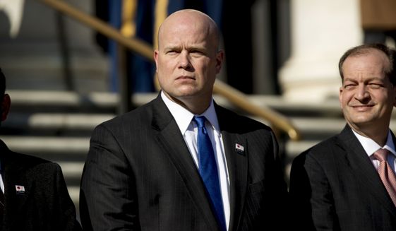 Acting United States Attorney General Matt Whitaker, center, and Labor Secretary Alex Acosta, right, attend a wreath laying ceremony at the Tomb of the Unknown Soldier during a ceremony at Arlington National Cemetery on Veterans Day, Sunday, Nov. 11, 2018 in Arlington, Va. (AP Photo/Andrew Harnik)
