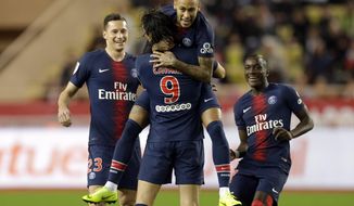 PSG&#39;s Edinson Cavani, center, celebrates with teammate Neymar, top center, after scoring his side&#39;s first goal of the game during the French League One soccer match between AS Monaco and Paris Saint-Germain at Stade Louis II in Monaco, Sunday, Nov. 11, 2018 (AP Photo/Claude Paris)