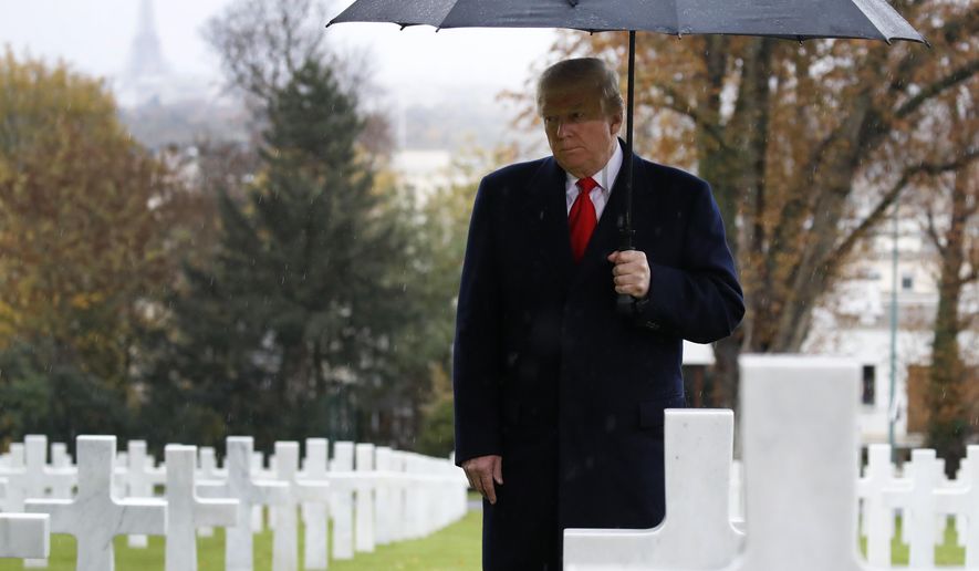 President Donald Trump stands amongst the headstones during an American Commemoration Ceremony, Sunday Nov. 11, 2018, at Suresnes American Cemetery near Paris. Trump is attending centennial commemorations in Paris this weekend to mark the Armistice that ended World War I. (AP Photo/Jacquelyn Martin)