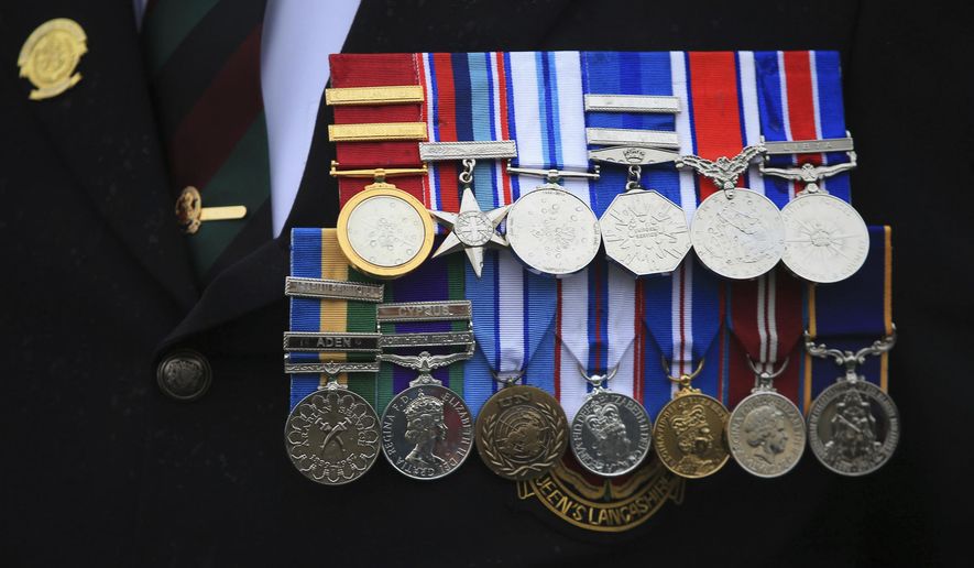 A veteran's medals are worn during a commemorative event to mark the Centennial of the ending of the First World War, in Blackpool, England, Sunday Nov. 11, 2018. The commemorative event marks the 100th anniversary of the signing of the Armistice which ended the First World War. (Danny Lawson/PA via AP)