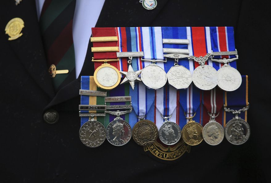 A veteran's medals are worn during a commemorative event to mark the Centennial of the ending of the First World War, in Blackpool, England, Sunday Nov. 11, 2018. The commemorative event marks the 100th anniversary of the signing of the Armistice which ended the First World War. (Danny Lawson/PA via AP)
