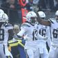 Los Angeles Chargers wide receiver Keenan Allen (13) is congratulated by teammates after scoring against the Oakland Raiders during the first half of an NFL football game in Oakland, Calif., Sunday, Nov. 11, 2018. (AP Photo/Ben Margot)