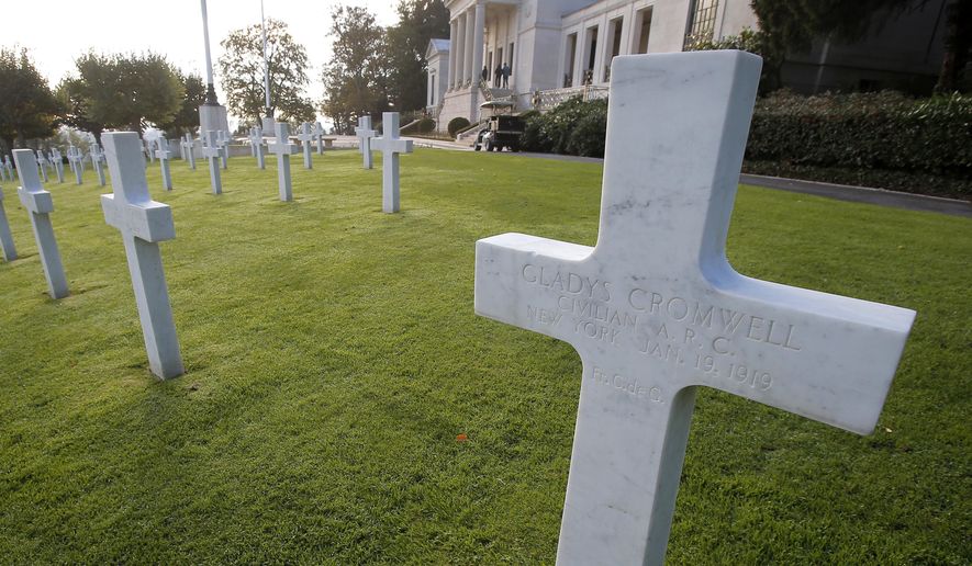 FILE - This file photo taken on Friday, Nov. 2, 2018 shows the graves of US nurses Dorothy Cromwell, left, and Gladys Cromwell, right, at the American Cemetery in Suresnes, near Paris, France. The two were beloved American nurses who worked tirelessness for Red Cross in France, but committed suicide shortly after the war overs the horrors they saw. (AP Photo/Michel Euler, File)