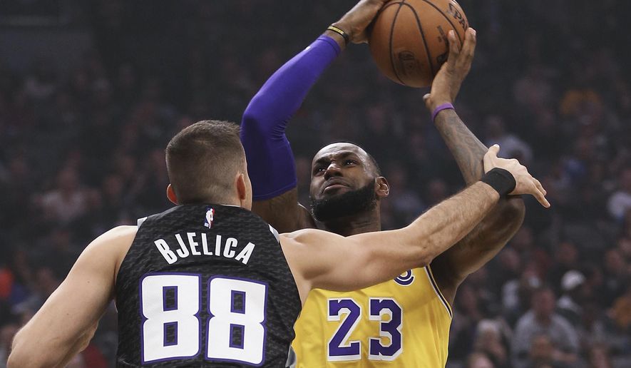 Los Angeles Lakers forward LeBron James, right, is fouled by Sacramento Kings forward Nemanja Bjelica during the second quarter of an NBA basketball game Saturday, Nov. 10, 2018, in Sacramento, Calif. .(AP Photo/Rich Pedroncelli)o