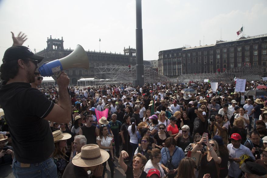 A man speaks during a protest in opposition to President-elect Andres Manuel Lopez Obrador's plans to cancel a new $13 billion airport for the capital, in Mexico City, Sunday Nov. 11, 2018. (AP Photo/Claudio Cruz)