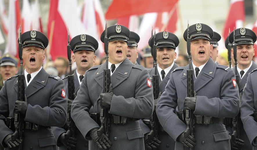 Polish Army soldiers salute during the official ceremony marking Poland's Independence Day, in Warsaw, Poland, Sunday, Nov. 11, 2018. The Independence Day in Poland celebrates the nation regaining its sovereignty at the end of World War I after being wiped off the map for more than a century. (AP Photo/Alik Keplicz)