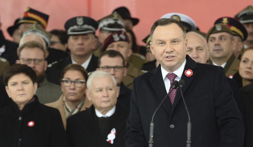 Polish President Andrzej Duda, right, speaks during the official ceremony marking Poland's Independence Day, in Warsaw, Poland, Sunday, Nov. 11, 2018, as leader of the ruling Law and Justice party, Jaroslaw Kaczynski, second left, stands behind. (AP Photo/Alik Keplicz) ** FILE **