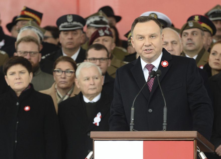 Polish President Andrzej Duda, right, speaks during the official ceremony marking Poland's Independence Day, in Warsaw, Poland, Sunday, Nov. 11, 2018, as leader of the ruling Law and Justice party, Jaroslaw Kaczynski, second left, stands behind. (AP Photo/Alik Keplicz) ** FILE **