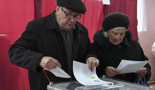 People cast their ballots at a polling station during rebel elections in Donetsk, Ukraine, Sunday, Nov. 11, 2018. Residents of the eastern Ukraine regions controlled by Russia-backed separatist rebels are voting for local governments in elections denounced by Kiev and the West. (AP Photo)