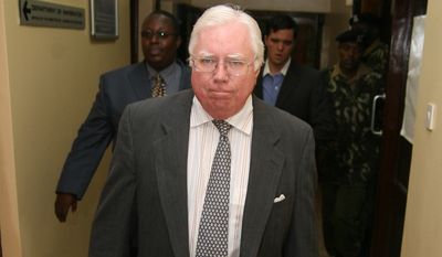Jerome Corsi, who wrote &quot;The Obama Nation: Leftist Politics and the Cult of Personality, walks down a corridor Tuesday, Oct. 7, 2008 as he arrives at the immigration department in Nairobi, Kenya.  Corsi, was picked up at his hotel in Nairobi on Tuesday morning. He was briefly detained before being brought to the airport for deportation, said Joseph Mumira, head of criminal investigations at Jomo Kenyatta International Airport. (AP Photo) **  KENYA OUT **