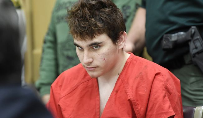 FILE - In this April 27, 2018 file photo, Florida school shooting suspect Nikolas Cruz, looks up while in court for a hearing in Fort Lauderdale, Fla. Attorneys for Cruz want a judge to prevent release of details of his education records to guarantee a fair trial. (Taimy Alvarez/South Florida Sun-Sentinel via AP, Pool, File)