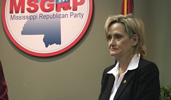 Republican U.S. Sen. Cindy Hyde-Smith of Mississippi appeared at a news conference at the state Republican Party headquarters in Jackson, Miss., on Monday, Nov. 12, 2018, and said repeatedly that she would not answer questions about a video that showed her at a Nov. 2 campaign event in Tupelo, Miss., where she praised a man by saying: &quot;If he invited me to a public hanging, I&#39;d be on the front row.&quot; Hyde-Smith issued a statement Sunday saying the remark was &quot;an exaggerated expression of regard&quot; for a friend who invited her to speak, and &quot;any attempt to turn this into a negative connotation is ridiculous.&quot; Hyde-Smith was appointed to serve temporarily in the Senate after longtime Republican Sen. Thad Cochran retired in April, and she faces an African-American Democrat, Mike Espy, in a Nov. 27, 2018, runoff. Espy is a former congressman and former U.S. agriculture secretary. The runoff winner will serve the final two years of the six-year term started by Cochran.  (AP Photo/Emily Wagster Pettus)