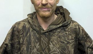 Christopher Thomas, 27, is shown in this booking photo provided by the Rochester, N.H. police, on Monday, Nov. 12, 2018. According to New Hampshire authorities, Thomas hid in the woods near a Walmart parking lot Sunday night, and opened fire on police helicopters overnight before he was arrestedm  New Hampshire authorities said Monday. Rochester police arrested Christopher Thomas, who they believe is homeless, on four counts of reckless conduct with a deadly weapon. (Rochester Police via AP)