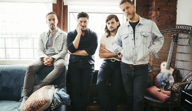 In this Sept. 28, 2018 photo, members of Mumford & Sons, from left, Ben Lovett, Marcus Mumford, Winston Marshall and Ted Dwane pose for a portrait in New York to promote their fourth album "Delta." (Photo by Victoria Will/Invision/AP)