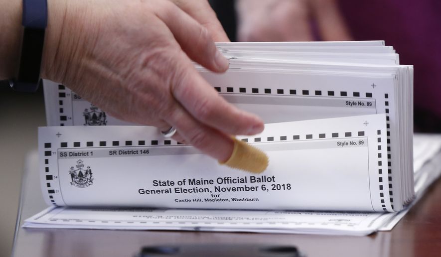 In this Nov. 12, 2018, file photo, ballots are prepared to be tabulated for Maine's 2nd Congressional District's House election in Augusta. Republican U.S. Rep. Bruce Poliquin and three voters sued Tuesday, Nov. 13, over Maine's new voting system, used for the first time in U.S. House and Senate elections. A lawyer for Poliquin's campaign asked the secretary of state to stop the tabulations to allow a judge to rule, but the secretary declined to stop the process. (AP Photo/Robert F. Bukaty, File)