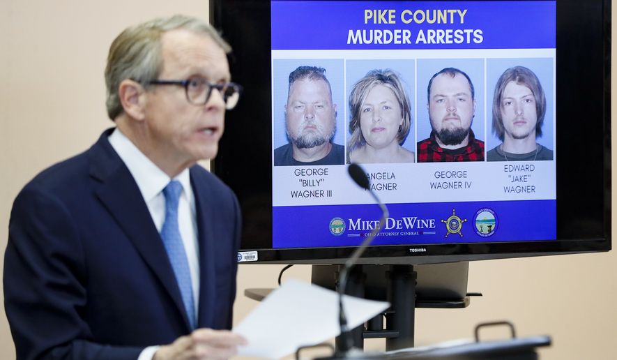 Ohio Attorney General Mike DeWine speaks alongside a display of those arrested during a news conference Tuesday, Nov. 13, 2018, in Waverly, Ohio, to discuss developments into the slayings of eight members of one family in rural Ohio two years ago,. A family of four was arrested Tuesday, the first break in a case that left a community reeling and surviving family members wondering if answers would ever come. Arrested were four members of the Wagner family, who lived near the scenes of the killing about 60 miles (97 kilometers) south of Columbus. (AP Photo/John Minchillo)