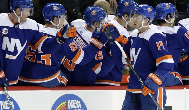 New York Islanders&#x27; Tom Kuhnhackl (14) celebrates a goal with teammates during the first period of an NHL hockey game against the Vancouver Canucks Tuesday, Nov. 13, 2018, in New York. (AP Photo/Frank Franklin II)