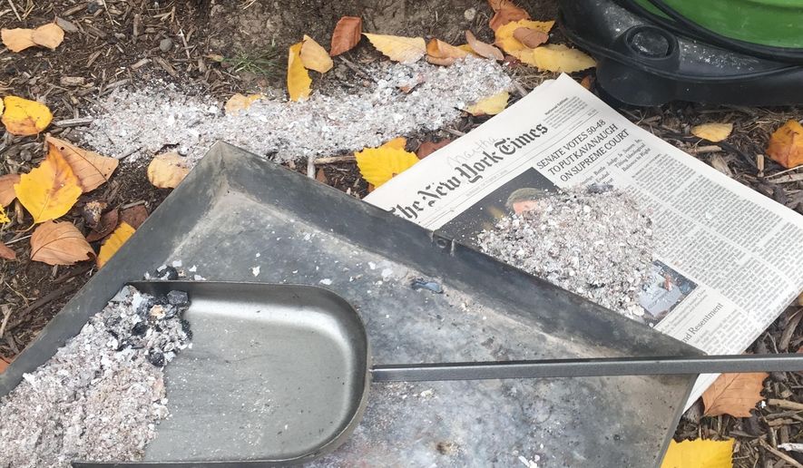 This Oct. 21, 2018 photo of wood stove ashes on a property near Langley, Wash., shows a nutrient-rich sample free of any residue from pressure-treated wood, painted wood or cardboard. They carry chemicals that can damage plants. The same goes for using charcoal from BBQ grills, fake fireplace logs and coal. Good quality wood ash is a soil amendment bonus for gardeners but beware using any containing additives. (Dean Fosdick via AP)