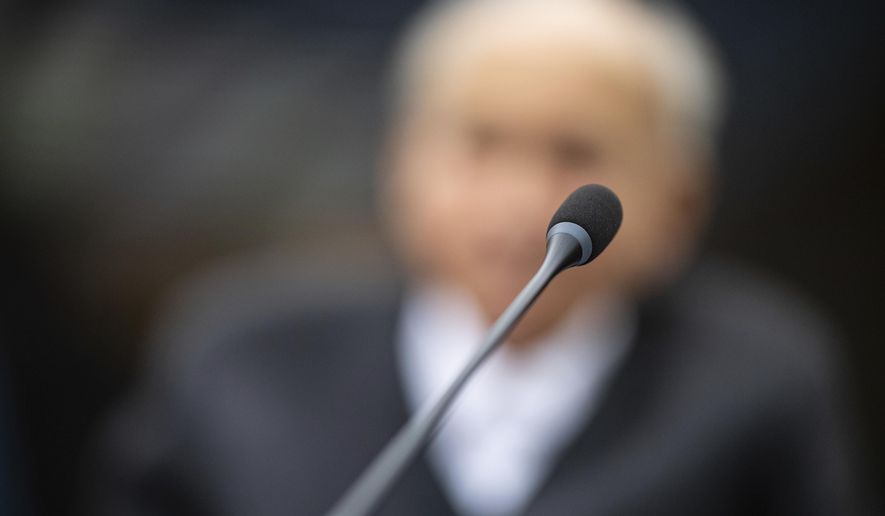 Johann Rehbogen, a 94-year-old former SS enlisted man, who is accused of hundreds of counts of accessory to murder for alleged crimes committed during the years he served as a guard at the Nazis’ Stutthof concentration camp, waits for the beginning of the third day of his trial at the regional court in Muenster, western Germany, Tuesday, Nov. 13, 2018. (Guido Kirchner/pool photo via AP)