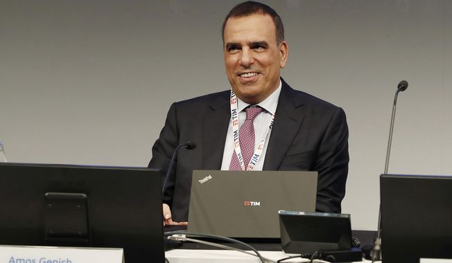 FILE - In this file photo taken May 4, 2018, Amos Genish smiles prior to the start of the shareholders meeting, in Rozzano, near Milan, Italy. A long-running board-room battle in Italy’s legacy telecoms provider, Telecom Italia, has culminated with the ouster of CEO Amos Genish, effective immediately. Telecom said in a statement Tuesday, Nov. 13, 2018 that the board will meet next Sunday to name a new CEO.  It gave no further explanation for the move. (AP Photo/Antonio Calanni, File )