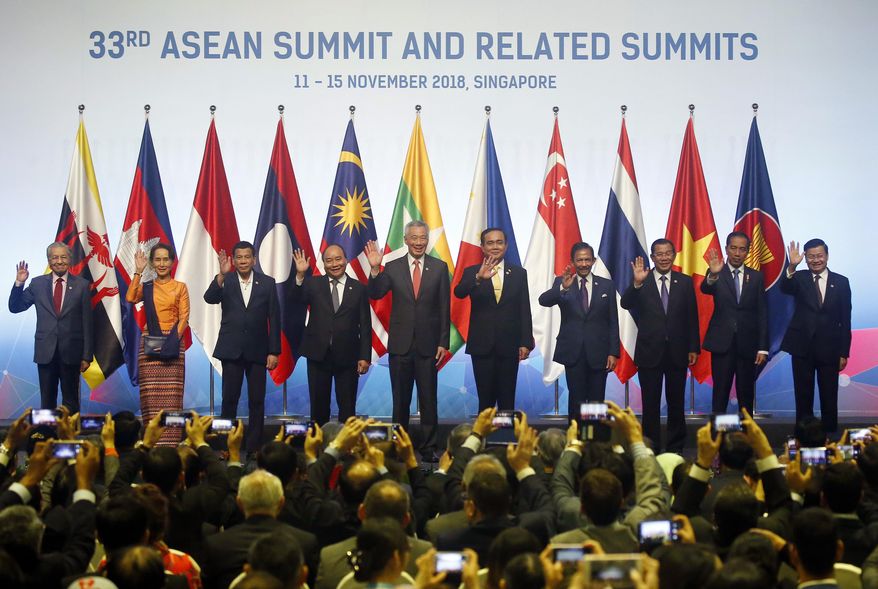 ASEAN Leaders pose for a group photo during the opening ceremony for the 33rd ASEAN Summit and Related Summits Tuesday, Nov. 13, 2018, in Singapore. From left; Prime Minister Mahathir Mohamad of Malaysia, Myanmar Leader Aung San Suu Kyi, President Rodrigo Duterte of The Philippines, Prime Minister Nguyen Xuan Phuc of Vietnam, Prime Minister Lee Hsien Loong of Singapore, Prime Minister Prayuth Chan-ocha of Thailand, Sultan Hassanal Bolkiah of Brunei, Prime Minister Hun Sen of Cambodia, President Joko Widodo of Indonesia and Prime Minister Thongloun Sisoulith of Laos. (AP Photo/Bullit Marquez)