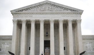 In this Oct. 9, 2018 photo, police office guards the main entrance to the Supreme Court in Washington. The Supreme Court will hear an appeal by Virginia Republicans who are trying to preserve state legislative districts that have been struck down by a lower court as racially discriminatory. (AP Photo/Pablo Martinez Monsivais)