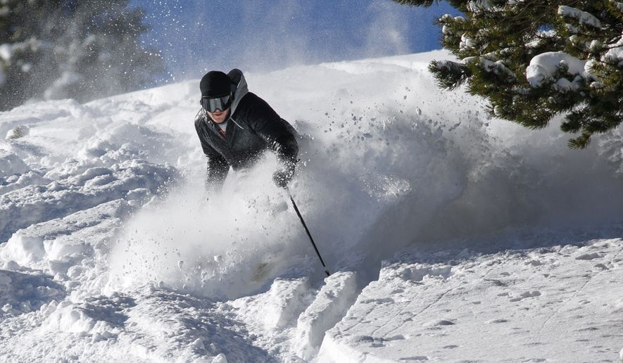 A skier makes a turn in fresh snow on Breckenridge Ski Resort&#39;s opening day Wednesday, Nov. 7, 2018, in Breckenridge, Colo. The resort opened early after receiving more than 5 feet of snow already this season. (Hugh Carey/Summit Daily News via AP)