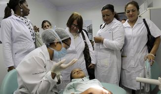 FILE - In this Aug. 30, 2013 file photo, Cuban doctors observe a dental procedure during a a training session at a health clinic in Brasilia, Brazil. Cuba said Wednesday, Nov. 14, 2018, it is ending a program that sent government doctors to remote regions of Brazil in exchange for millions in badly needed dollars. The end of the &amp;quot;Mas Medicos,&amp;quot; or &amp;quot;More Doctors,&amp;quot; program signals a sharp deterioration in relations between communist Cuba and Brazil, which just elected far-right presidential candidate Jair Bolsonaro. (AP Photo/Eraldo Peres, File)