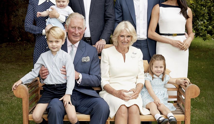In this handout image provided by Clarence House and taken on Sept. 5, 2018, Britain's Prince Charles poses for an official portrait to mark his 70th Birthday in the gardens of Clarence House, with Camilla, Duchess of Cornwall, Prince William, Kate, Duchess of Cambridge, Prince George, Princess Charlotte, Prince Louis, Prince Harry and Meghan, Duchess of Sussex, in London, England. (Chris Jackson/Pool Photo)