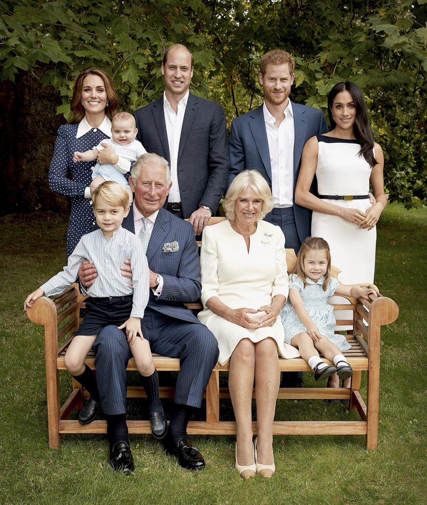 In this handout image provided by Clarence House and taken on Sept. 5, 2018, Britain's Prince Charles poses for an official portrait to mark his 70th Birthday in the gardens of Clarence House, with Camilla, Duchess of Cornwall, Prince William, Kate, Duchess of Cambridge, Prince George, Princess Charlotte, Prince Louis, Prince Harry and Meghan, Duchess of Sussex, in London, England. (Chris Jackson/Pool Photo)
