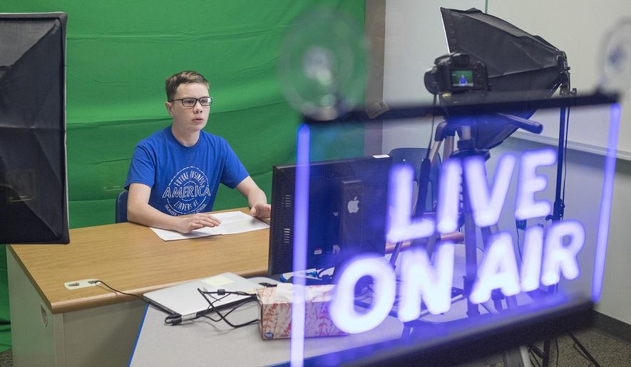Adam Engel records his show &amp;quot;Mingle with Engel&amp;quot; on a recent Monday, Oct 22, 2018 morning at Thunder Basin High School. Engel then edits the footage to be shown with the school&#39;s news program on Tuesdays. (Rhianna Gelhart/Gillette News Record via AP)