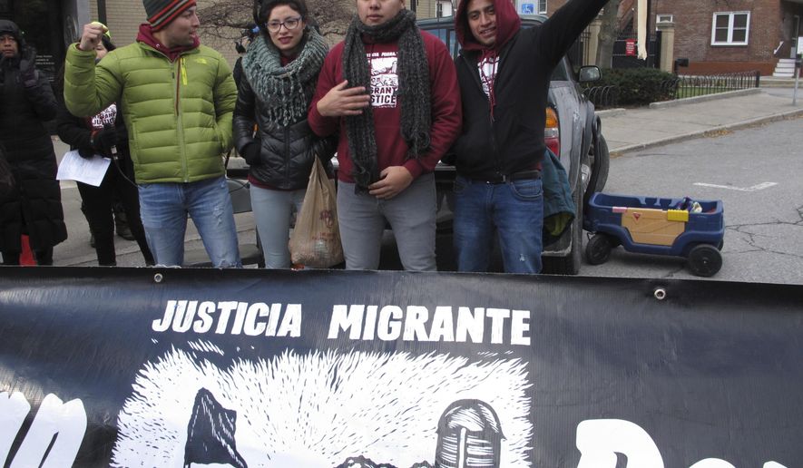 Members of the advocacy group Migrant Justice stand before the federal court in Burlington, Vt., on Wednesday, Nov. 14, 2018. They filed a lawsuit against the Department of Homeland Security, Immigration and Customs Enforcement and the Vermont Department of Motor Vehicles alleging that ICE targeted and arrested members in retaliation for their activism. (AP Photo/Lisa Rathke)