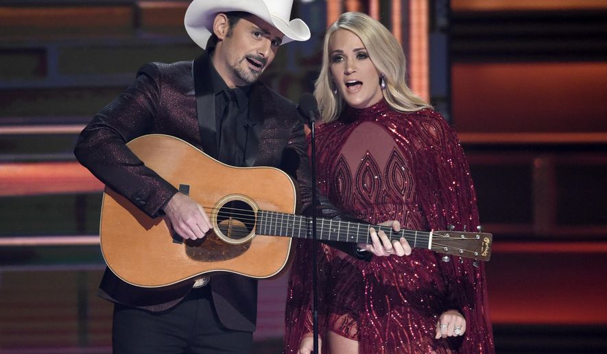 Brad Paisley, left, and Carrie Underwood during the opening of the 51st annual CMA Awards in Nashville, Tennessee, Nov. 8, 2017. (Photo by Chris Pizzello/Invision/AP, File)