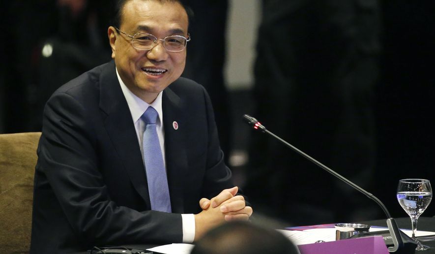 Chinese Premier Li Keqiang smiles as he glances at ASEAN leaders after delivering his statement at the ASEAN Plus China Summit in the ongoing 33rd ASEAN Summit and Related Summits Wednesday, Nov. 14, 2018 in Singapore. China&#39;s premier sought Tuesday to reassure its neighbors that Beijing will push ahead with reforms needed to support growth across the region and also keep the peace in contested waters in the South China Sea. (AP Photo/Bullit Marquez)