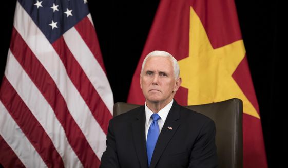 U.S. Vice President Mike Pence listens to Vietnam&#39;s Prime Minister Nguyen Xuan Phuc, not seen, in Singapore, Wednesday, Nov. 14, 2018. Pence is Singapore to attend the 33rd ASEAN summit. (AP Photo/Bernat Armangue, Pool)