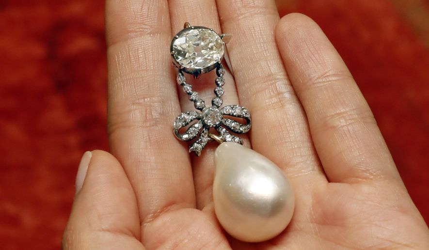 FILE - In this Friday, Oct. 12, 2018 file photo, the Queen Marie Antoinette Pearl and diamond pendant, from the 18th century, is displayed at Sotheby's, in New York. A large, drop-shaped natural pearl pendant sold for a hammer price of $32 million at an auction of jewelry that once belonged to French queen Marie Antoinette, which Sotheby’s is calling a record price for a pearl at auction. The “Queen Marie Antoinette's Pearl," a diamond-and-pearl pendant, was among the highlight offerings on the block at the Sotheby’s sale of jewelry from the Bourbon-Parma dynasty on Wednesday, Nov. 14. (AP Photo/Richard Drew, file)