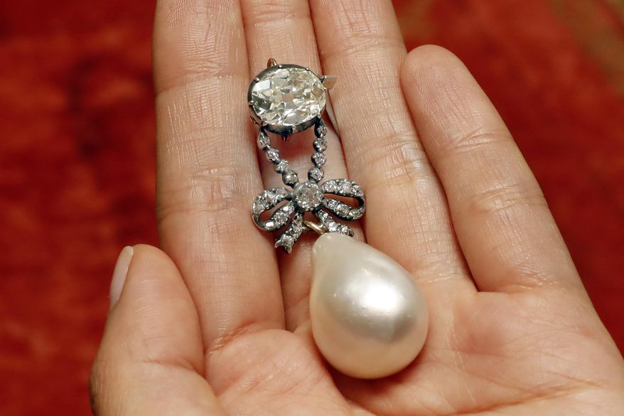 FILE - In this Friday, Oct. 12, 2018 file photo, the Queen Marie Antoinette Pearl and diamond pendant, from the 18th century, is displayed at Sotheby's, in New York. A large, drop-shaped natural pearl pendant sold for a hammer price of $32 million at an auction of jewelry that once belonged to French queen Marie Antoinette, which Sotheby’s is calling a record price for a pearl at auction. The “Queen Marie Antoinette's Pearl," a diamond-and-pearl pendant, was among the highlight offerings on the block at the Sotheby’s sale of jewelry from the Bourbon-Parma dynasty on Wednesday, Nov. 14. (AP Photo/Richard Drew, file)