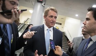 Then-Sen. Jeff Flake, R-Ariz., speaks with reporters before he and Sen. Chris Coons, D-Del., try to bring up the legislation to protect special counsel Robert Mueller, at the Capitol in Washington, Wednesday, Nov. 14, 2018. Senate Republicans are facing renewed pressure to pass legislation to protect Mueller, with a handful of GOP senators urging their leadership to hold a vote now that President Donald Trump has pushed out Attorney General Jeff Sessions. (AP Photo/J. Scott Applewhite)
