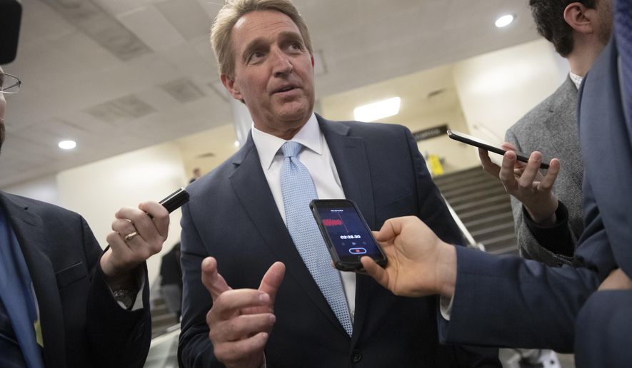 Sen. Jeff Flake, R-Ariz., speaks with reporters before he and Sen. Chris Coons, D-Del., try to bring up the legislation to protect special counsel Robert Mueller, at the Capitol in Washington, Wednesday, Nov. 14, 2018. Senate Republicans are facing renewed pressure to pass legislation to protect Mueller, with a handful of GOP senators urging their leadership to hold a vote now that President Donald Trump has pushed out Attorney General Jeff Sessions. (AP Photo/J. Scott Applewhite)