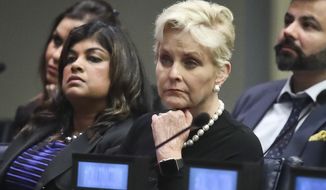 Cindy McCain, second from right, co-chair of the McCain Institute&#39;s Human Trafficking Advisory Council, and trafficking survivor Rani Hong, second from left, listen after addressing the human rights conference, &quot;Stepping Up Action to End Forced Labour, Modern Slavery and Human Trafficking,&quot; during the United Nations General Assembly, Monday Sept. 24, 2018, at U.N. headquarters. (AP Photo/Bebeto Matthews) ** FILE **