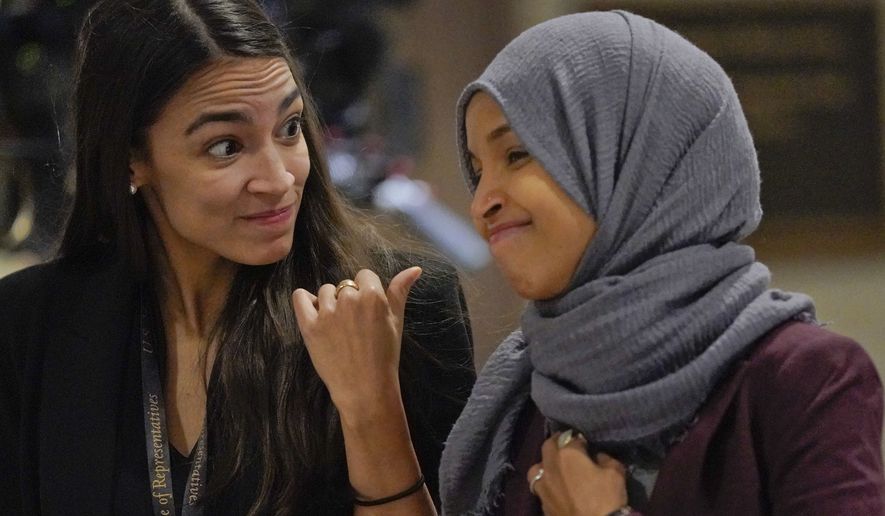 Rep.-elect Alexandria Ocasio-Cortez, D-NY., left, talks with Rep.-elect IIhan Omar, D-Minn., right, as they walk over to member-elect briefings on Capitol Hill in Washington, Thursday, Nov. 15, 2018. (AP Photo/Pablo Martinez Monsivais)