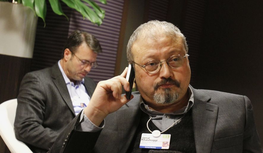 In this Jan. 29, 2011, file photo, Saudi journalist Jamal Khashoggi speaks on his cellphone at the World Economic Forum in Davos, Switzerland. (AP Photo/Virginia Mayo, File)