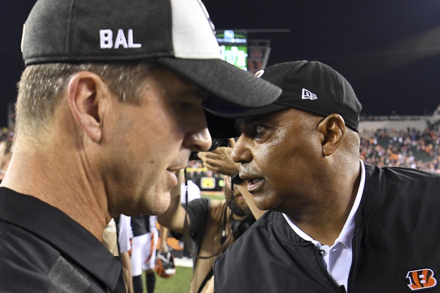 FILE - In this Sept. 13, 2018, file photo, Cincinnati Bengals head coach Marvin Lewis, right, meets with Baltimore Ravens head coach John Harbaugh, left, after their NFL football game in Cincinnati. The Ravens (4-5) and Bengals (5-4) fully expected to be in a better place entering Sunday&#39;s rematch of a Sept. 13 matchup Cincinnati won 34-23. After a 4-2 start, Baltimore has lost three straight. The Bengals, similarly, have dropped four of five after opening 4-1. (AP Photo/Bryan Woolston, File)