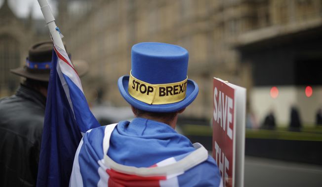 Anti-Brexit supporter Steve Bray from south Wales, protests outside the Houses of Parliament in London, Thursday Nov. 15, 2018. Leading Brexiteer Jacob Rees-Mogg has submitted a letter of no confidence in Theresa May, as the Prime Minister reels from the loss of four ministers - including two from her Cabinet - in protest at her Brexit plans. (AP Photo/Matt Dunham)