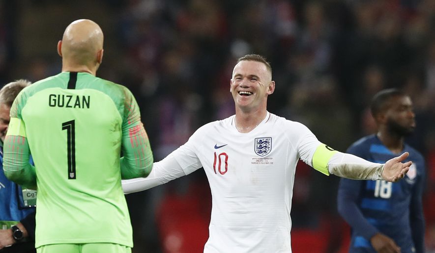 England&#39;s Wayne Rooney, right, jokes with Unites States goalkeeper Brad Guzan who stopped Rooney&#39;s shot on goal during the international friendly soccer match between England and the United States at Wembley stadium, Thursday, Nov. 15, 2018. (AP Photo/Alastair Grant)