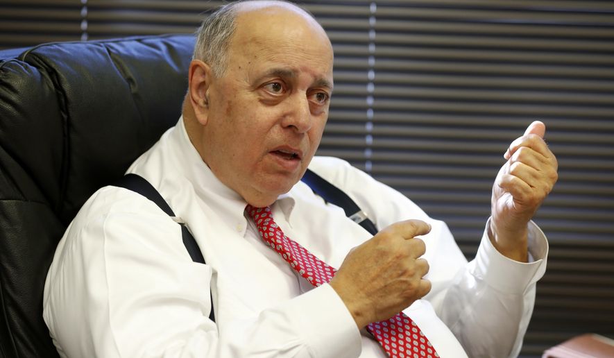 In this Tuesday, Nov. 13, 2018 photo, former Judge Robert Rosenberg, gestures as he speaks during an interview with The Associated Press, at his office in Plantation, Fla. Rosenberg was on the Broward County Canvassing Board during the 2000 presidential election between George W. Bush and Al Gore. (AP Photo/Wilfredo Lee)