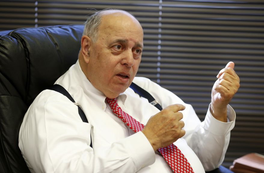 In this Tuesday, Nov. 13, 2018 photo, former Judge Robert Rosenberg, gestures as he speaks during an interview with The Associated Press, at his office in Plantation, Fla. Rosenberg was on the Broward County Canvassing Board during the 2000 presidential election between George W. Bush and Al Gore. (AP Photo/Wilfredo Lee)